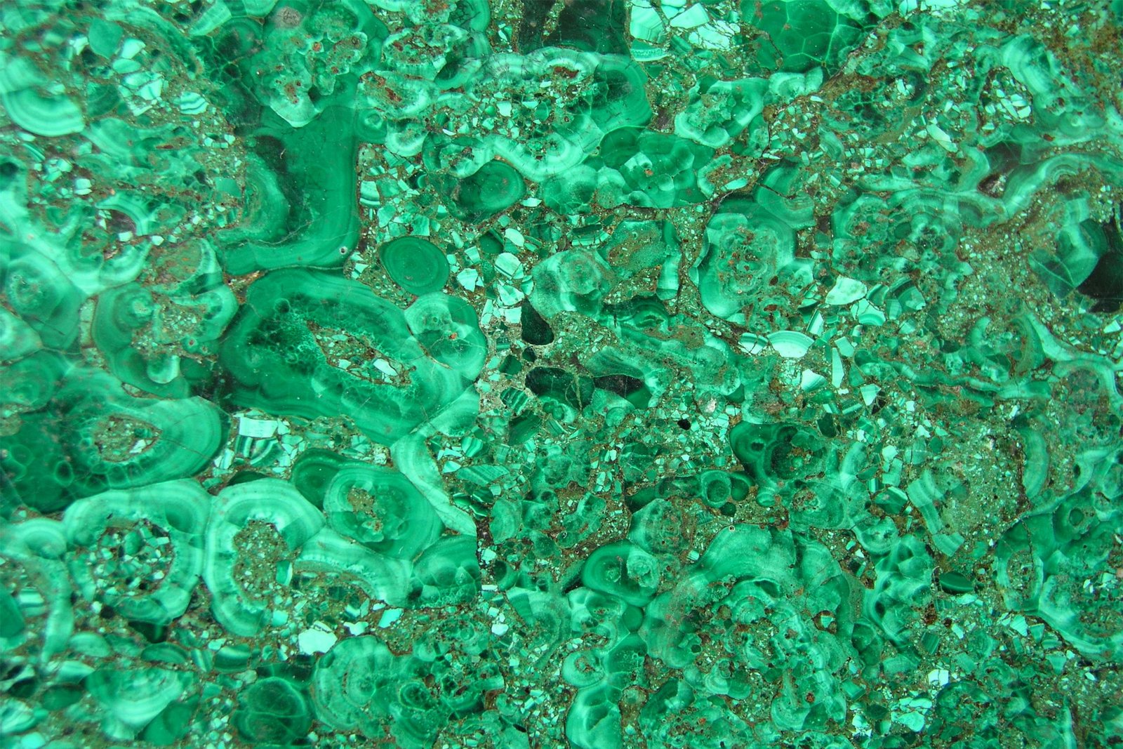 Close-up view of rich green malachite stone texture with intricate patterns.